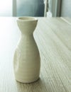 Sake bottle on wooden table Royalty Free Stock Photo