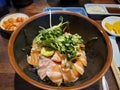 Sake-don, or Salmon donburi, Japanese traditional rice bowl dish topped with stacks of raw salmon belly, wasabi and sprout. Royalty Free Stock Photo