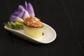 Sake Green Gunkan Maki sushi with salmon pieces wrapped in cucumber slice. Violet flower on white plate with dark background Royalty Free Stock Photo