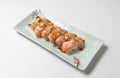 Sake nigiri on a ceramic plate isolated on a white background