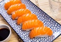 Sake nigiri - dietary sushi with salmon and tuna, soy sauce closeup Royalty Free Stock Photo