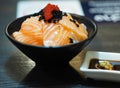 Sake Salmon Rice Japanese Style Chirashi scattered topping with Tobiko Flying fish roe in black bowl Royalty Free Stock Photo