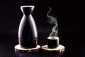 Sake a traditional distilled and fermented alcoholic drink from Japan served hot produced from rice water and kÃÂji. Black