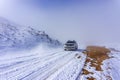 The white pick up truck is riding on snow at a foggy day in Antalya, Turkey Royalty Free Stock Photo