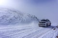 The white pick up truck is riding on snow at a foggy day in Antalya, Turkey Royalty Free Stock Photo