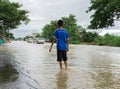 SAKON NAKHON, THAILAND - JULY 29, 2017 : Boy walking with water Royalty Free Stock Photo