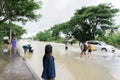 SAKON NAKHON, THAILAND - JULY 29, 2017 : People walking in streets water flooded Royalty Free Stock Photo