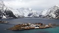 Sakrisoy island between snow covered mountains at the Reinefjorden on the Lofoten in Norway in winter