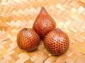 Salacca zalacca, Salak Palm or Snake Fruit in woven bamboo on the table.