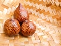 Salacca zalacca, Salak Palm or Snake Fruit in woven bamboo on the table.