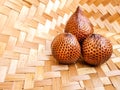 Salacca zalacca, Salak Palm or Snake Fruit in woven bamboo on the table.