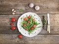 Salad with arugula, cherry tomatoes, sunflower seeds and herbs on white ceramic plate Royalty Free Stock Photo