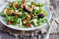 Salad with arugula, figs, cheese and pecans