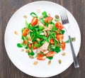 Salad with arugula, salmon and cherry tomato