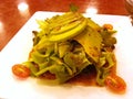 Salad with avocado and cherry tomatoes with japanese salad dressing on white dish - closeup