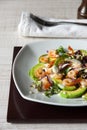 Salad with avocado , prawns and arugula on the ceramic plate