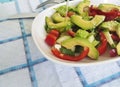 Salad with avocado and sesame seeds, oil is poured on a wooden Royalty Free Stock Photo