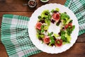 Salad with baked beet, blue cheese, ham and green mix with pesto. Royalty Free Stock Photo