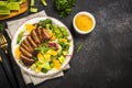 Salad with baked duck, green salad mix and oranges.