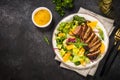 Salad with baked duck, green salad mix and oranges.