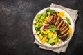 Salad with baked duck, green salad mix and oranges.