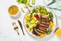 Salad with baked duck, green salad mix and oranges.