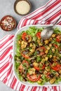 Salad baked eggplant and fresh tomatoes with spicy dressing and sesame seeds