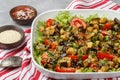 Salad baked eggplant and fresh tomatoes with spicy dressing and sesame seeds