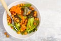 Salad with baked pumpkin and chickpeas with mustard-honey dressing in a white plate, top view. Healthy vegan food concept. Royalty Free Stock Photo