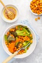 Salad with baked pumpkin and chickpeas with mustard-honey dressing in a white plate, top view. Healthy vegan food concept. Royalty Free Stock Photo