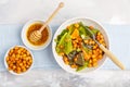 Salad with baked pumpkin and chickpeas with mustard-honey dressing in a white plate, top view. Healthy vegan food concept. Royalty Free Stock Photo