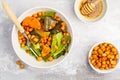 Salad with baked pumpkin and chickpeas with mustard-honey dressing in a white plate, top view. Healthy vegan food concept. Royalty Free Stock Photo