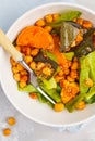 Salad with baked pumpkin and chickpeas with mustard-honey dressing in a white plate, top view. Healthy vegan food concept. Royalty Free Stock Photo