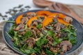 Salad with baked pumpkin, lentils on a table