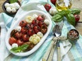 Salad. Baked tomato, basil, garlic with mozzarella cheese in ceramic dishes. cooking, cooked dish