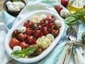 Salad. Baked tomato, basil, garlic with mozzarella cheese, ceramic dishes. cooking, cooked dish, top view