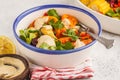 Salad with baked vegetables with tahini in white plate, white ba Royalty Free Stock Photo