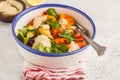 Salad with baked vegetables with tahini in white plate, white ba Royalty Free Stock Photo