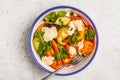 Salad with baked vegetables with tahini in white plate, white ba Royalty Free Stock Photo