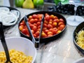 Salad bar. Salad buffet at restaurant. Fresh salad bar buffet for lunch or dinner. Healthy eating. Red tomatoes in bowl on counter Royalty Free Stock Photo