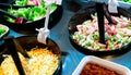 Salad bar buffet at restaurant. Fresh salad bar buffet for lunch or dinner. Healthy food. Celery and crab stick sliced in black Royalty Free Stock Photo