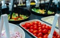 Salad bar buffet at restaurant. Fresh salad bar buffet for lunch or dinner. Healthy food. Selective focus on red tomatoes in white Royalty Free Stock Photo