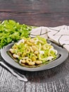 Salad of beans and olives in plate on wooden board Royalty Free Stock Photo