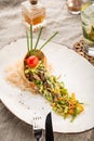 Salad with beef, sesame seeds and vegetables in tortilla on white plate Royalty Free Stock Photo