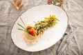 Salad with beef, sesame seeds and vegetables in tortilla on white plate Royalty Free Stock Photo