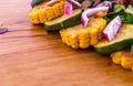 Salad with beef slices, grilled vegetables - eggplant, corn, mushrooms, sauce on a wooden board, dish Royalty Free Stock Photo