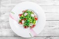 Salad with beef steak, baby spinach, lettuce, sweet pepper and grains of pomegranate on wooden background close up Royalty Free Stock Photo