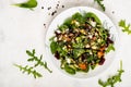 Salad with beetroot, avocado, feta cheese, rucola, tomato, various greens, pumpkin seeds in a white bowl. Diet healthy