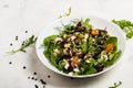 Salad with beetroot, avocado, feta cheese, rucola, tomato, various greens, pumpkin seeds in a white bowl. Diet healthy