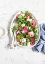 Salad with beets, arugula, feta cheese and walnuts. On a light background Royalty Free Stock Photo